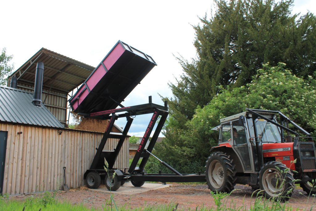 Agricultural tractor trailer extending grain dump